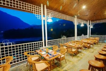 Riverside seating area with mango trees